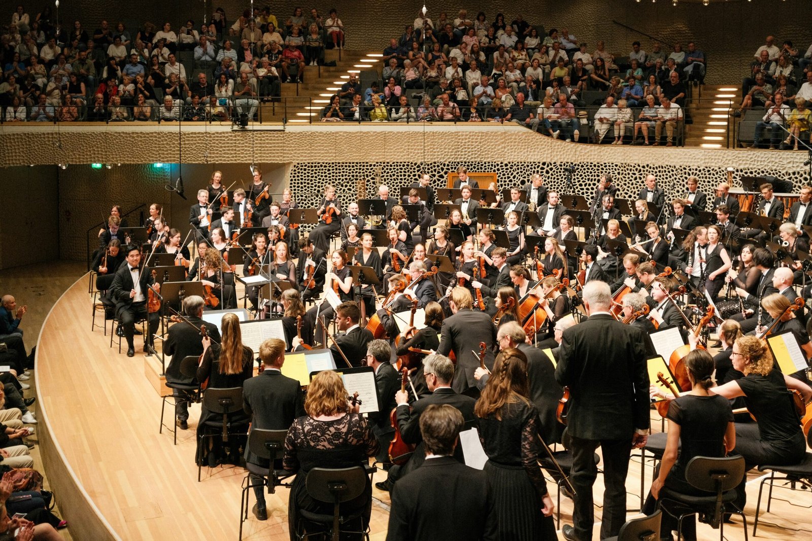 Orchestra performing in a grand concert hall